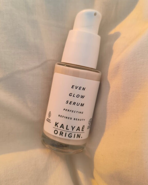 Even Glow Serum unifiant éclat certifié COSMOS NATURAL 30 ml présenté en avis client sur drap clair avec lumière douce – KALYAË ORIGIN