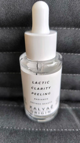 Lactic Clarity Peeling exfoliant éclat certifié COSMOS NATURAL 30 ml présenté en avis client sur fond textile gris – KALYAË ORIGIN
